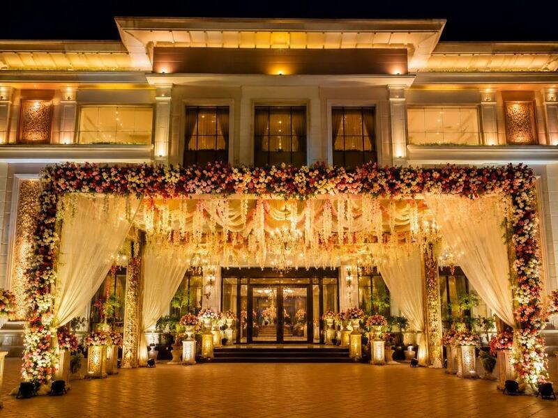 Elegant engagement banquet hall decoration with floral stage and lights