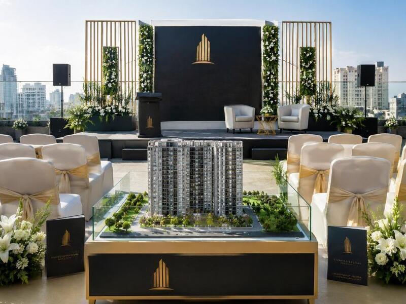 Luxury rooftop real estate corporate event setup with premium seating and property model display in Kolkata