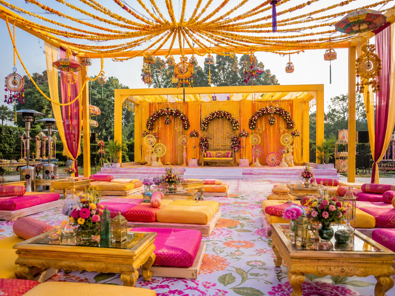 Outdoor Mehndi decoration setup for a colourful garden wedding celebration