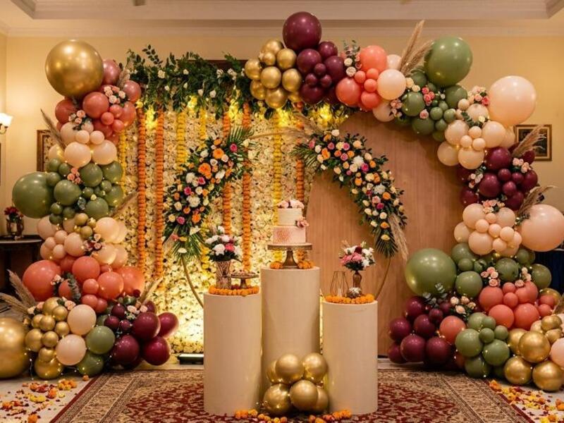 modern birthday balloon decoration setup with pastel and organic style